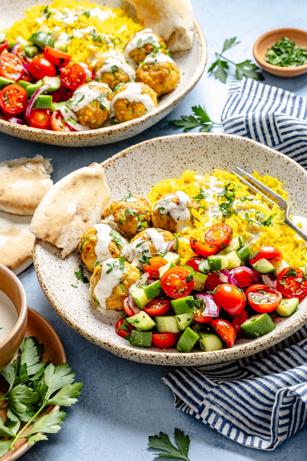 chicken shawarma meatballs bowls with rice, salad, and pita bread