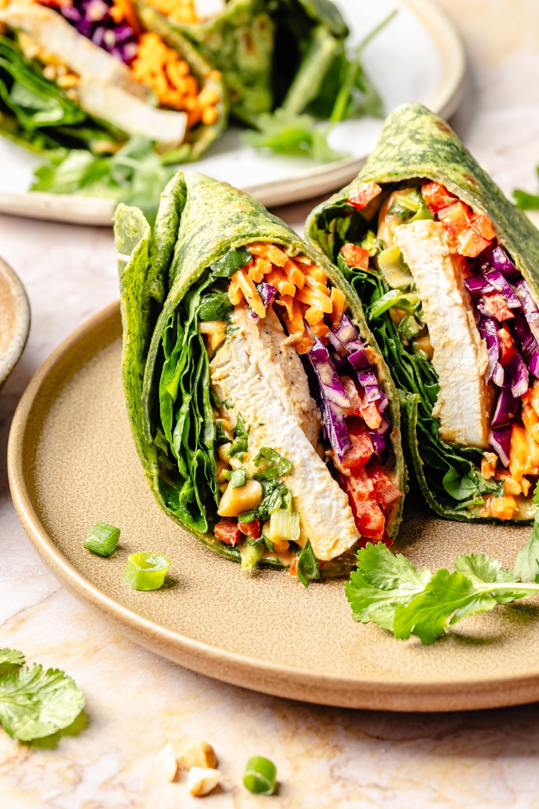 thai peanut chicken wrap sliced on a plate