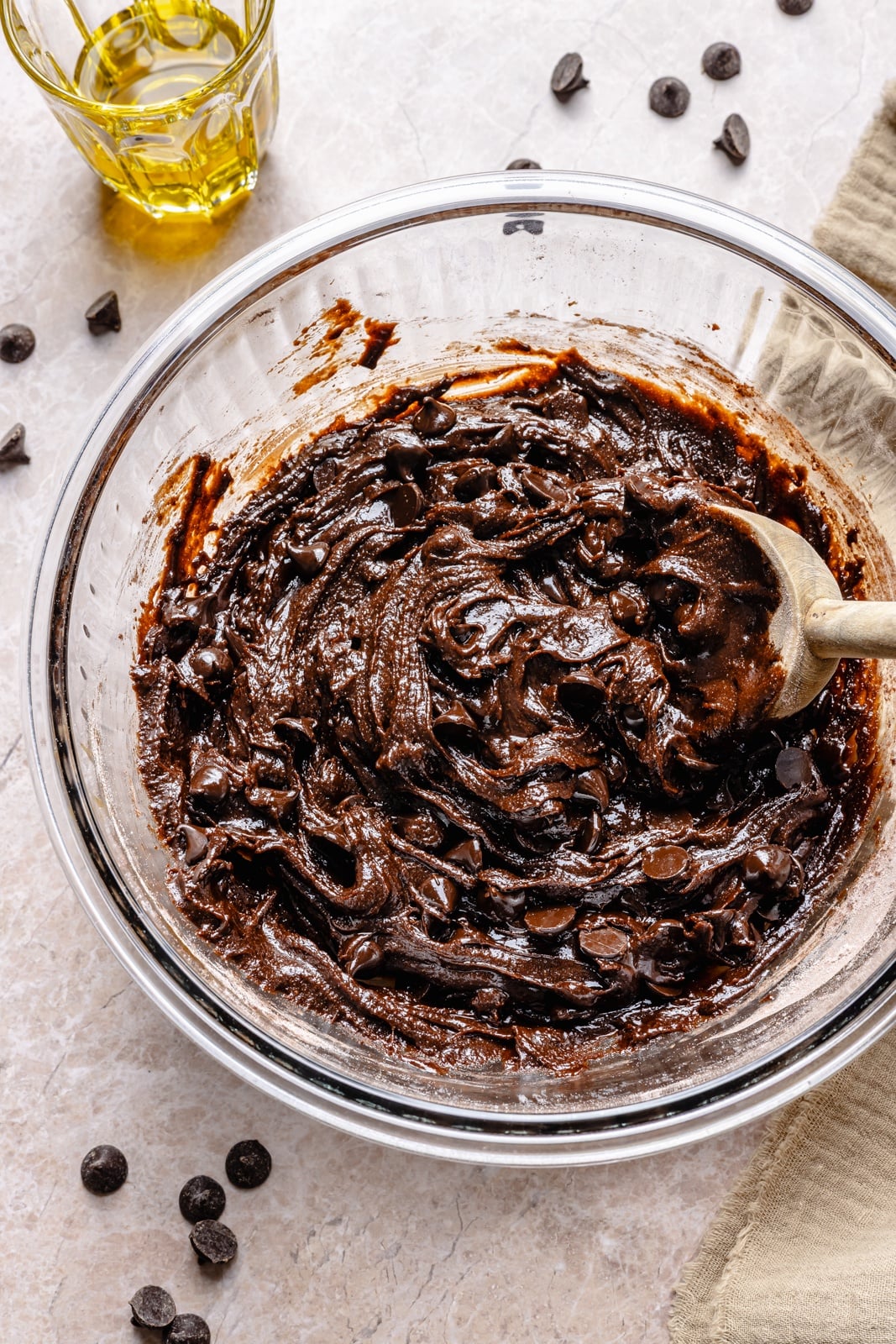 Fudgy double chocolate olive oil cookies with perfectly crisp edges and chewy centers. These incredible cookies take just 10 minutes to mix and 10 to bake, so you can have the ultimate chocolate lover's dessert in no time! Easily make them gluten-free, and add a sprinkle of sea salt for a sweet-salty combo. mixing dough for chocolate olive oil cookies