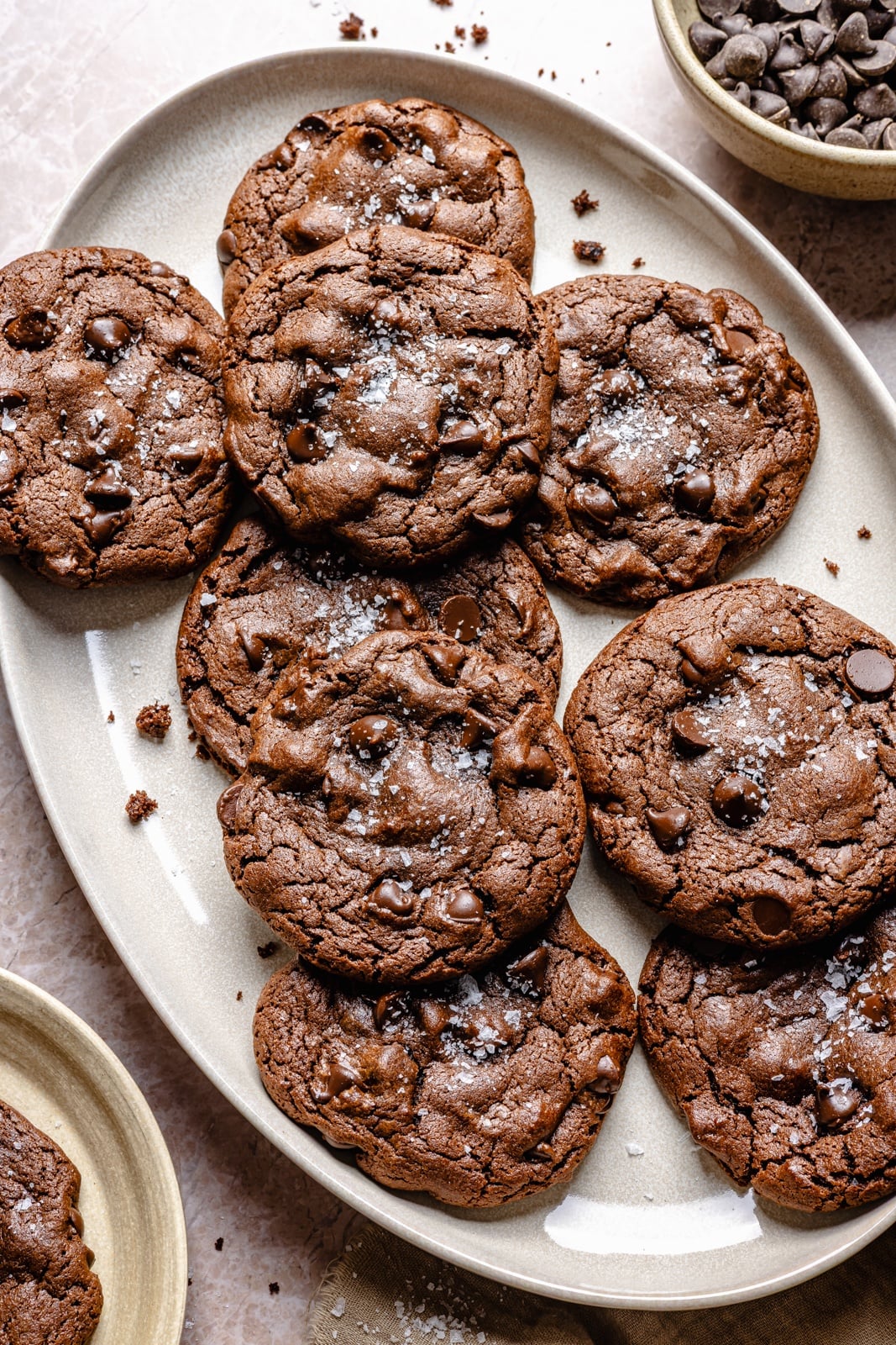 Fudgy double chocolate olive oil cookies with perfectly crisp edges and chewy centers. These incredible cookies take just 10 minutes to mix and 10 to bake, so you can have the ultimate chocolate lover's dessert in no time! Easily make them gluten-free, and add a sprinkle of sea salt for a sweet-salty combo. chewy chocolate olive oil cookies on a platter