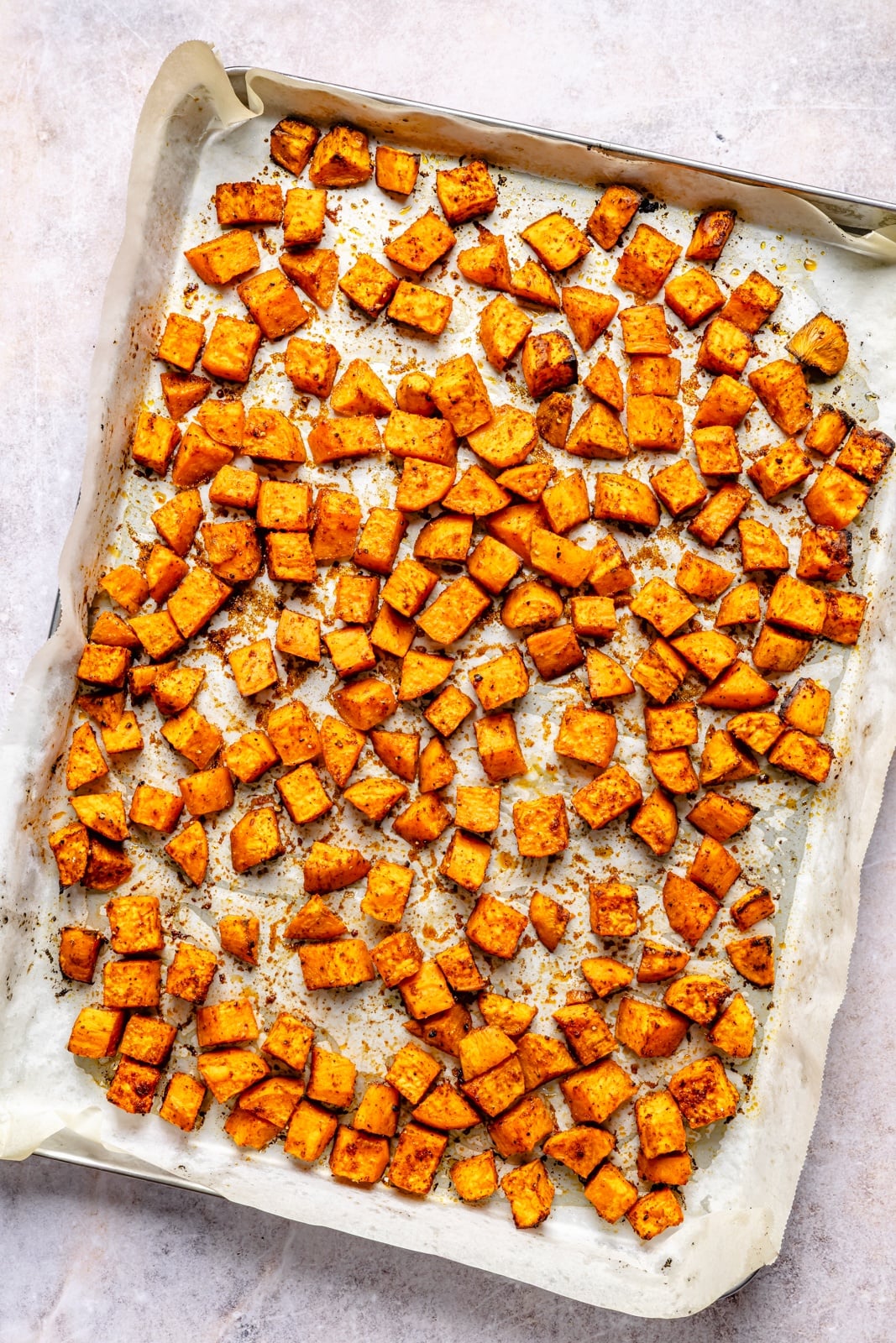 Easy, protein-packed sloppy joe bowls with spiced sweet potatoes, a sneaky rainbow of veggies, and delicious, savory toppings. Fuel your weekday with these nourishing meal prep bowls, and scoop them up with chips for a yummy crunch! roasted sweet potatoes on a baking sheet