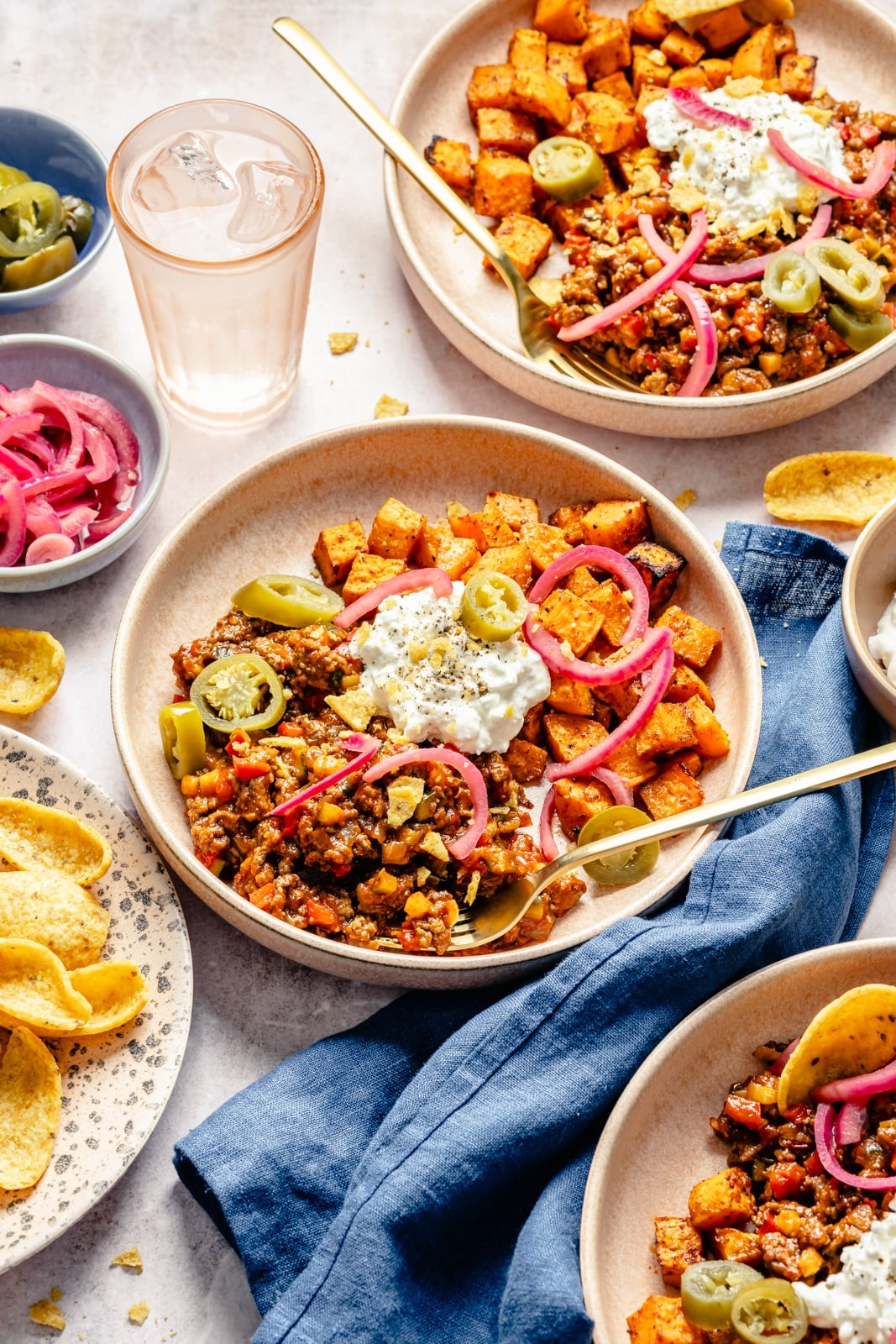 Easy, protein-packed sloppy joe bowls with spiced sweet potatoes, a sneaky rainbow of veggies, and delicious, savory toppings. Fuel your weekday with these nourishing meal prep bowls, and scoop them up with chips for a yummy crunch! healthy sloppy joe bowls with sweet potatoes and cottage cheese