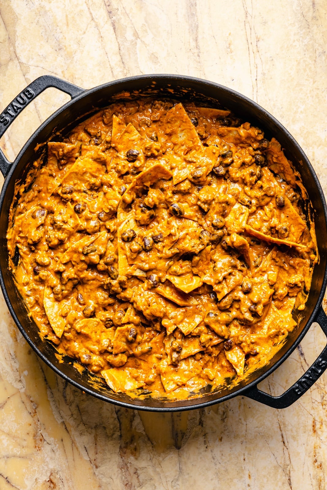 beef, pumpkin sauce, and tortilla strips in a skillet