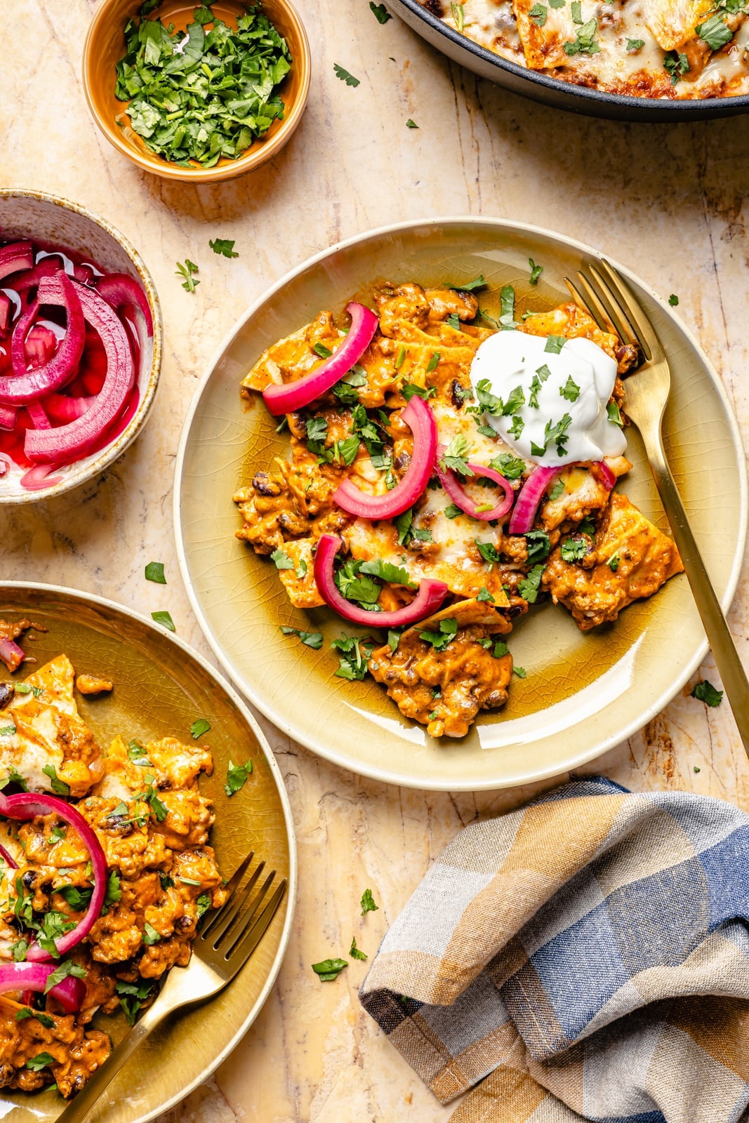 cheesy beef and pumpkin enchilada skillet on two plates