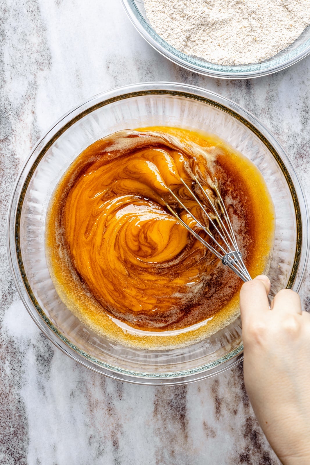 Fluffy butternut squash muffins infused with homemade chai spices, then topped with a simple salted honey glaze that truly takes these to the next level. These fall-inspired, freezer-friendly butternut squash muffins are easy to make and have hints of caramel flavor thanks to a touch of brown butter. Perfect with a cup of coffee! mixing batter for butternut squash muffins