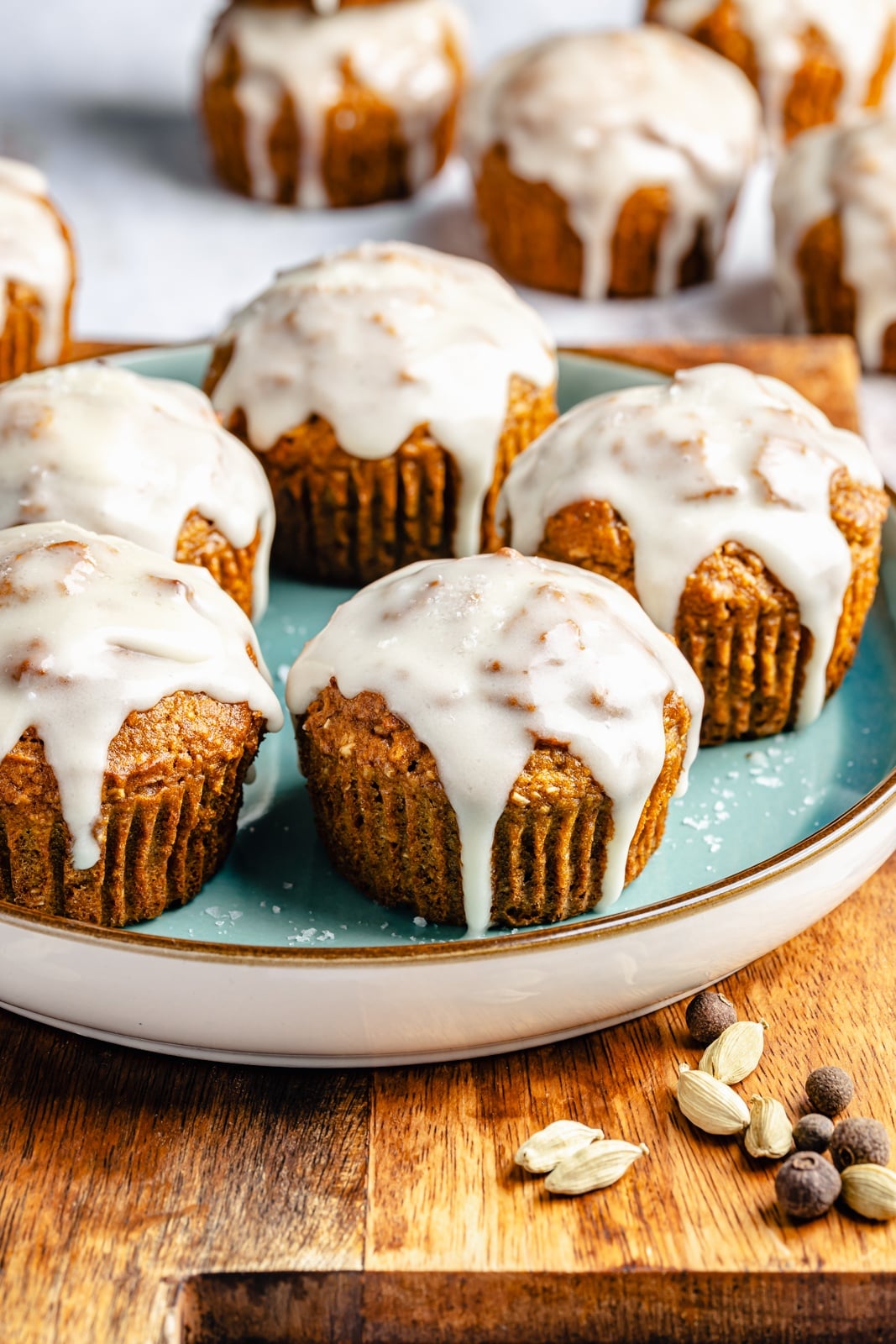 Fluffy butternut squash muffins infused with homemade chai spices, then topped with a simple salted honey glaze that truly takes these to the next level. These fall-inspired, freezer-friendly butternut squash muffins are easy to make and have hints of caramel flavor thanks to a touch of brown butter. Perfect with a cup of coffee! butternut squash muffins with honey glaze on a plate